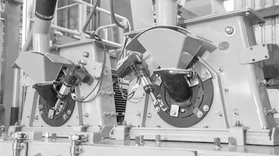 CYM blast wheel turbines — original spare parts Detail of two CYM shot blasting blast wheels dismounted for maintenance showing impeller discs and housing parts